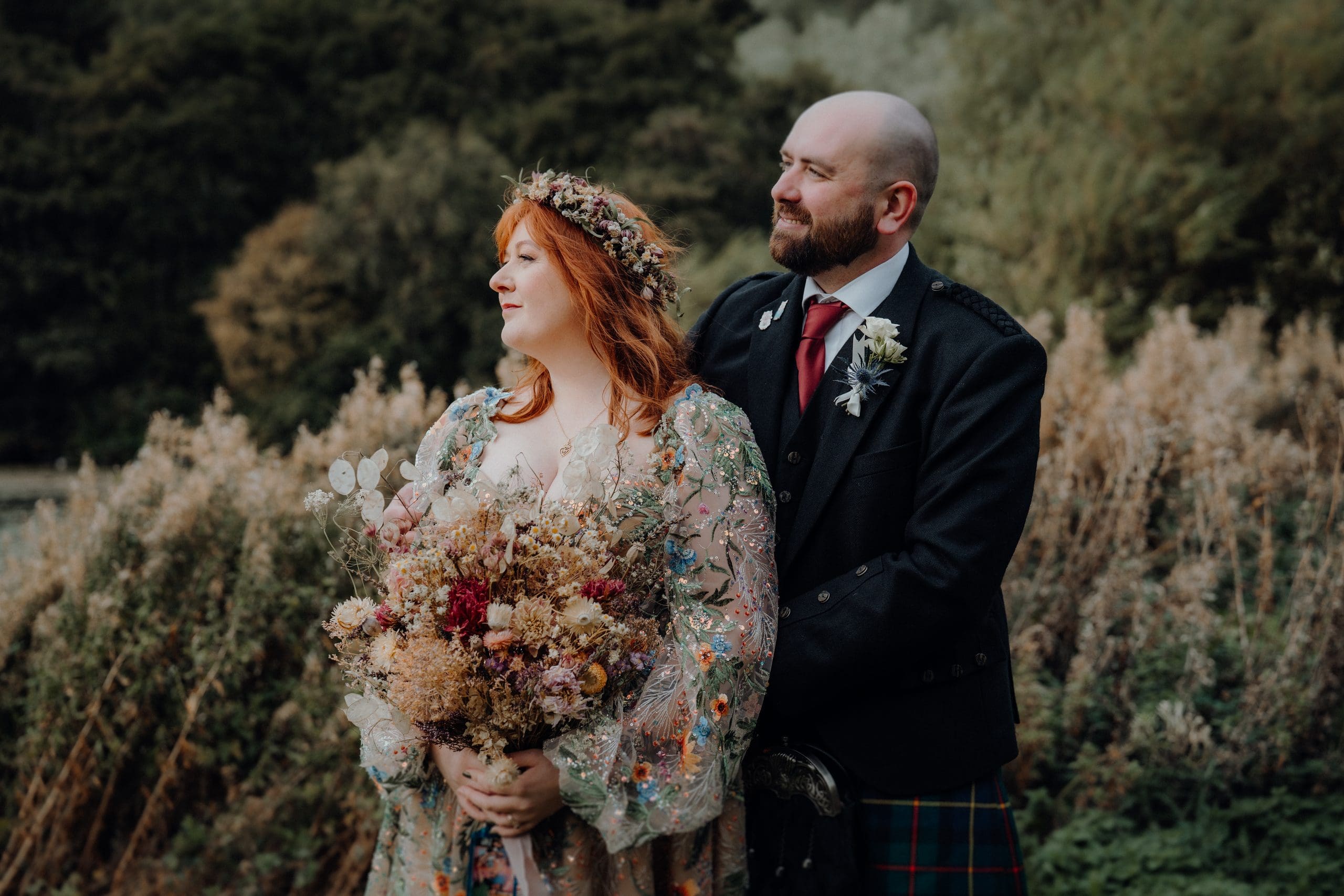 Bride and Groom on the banks of Duddingston Loch after their wedding.  Autumn wedding / documentary photographer 